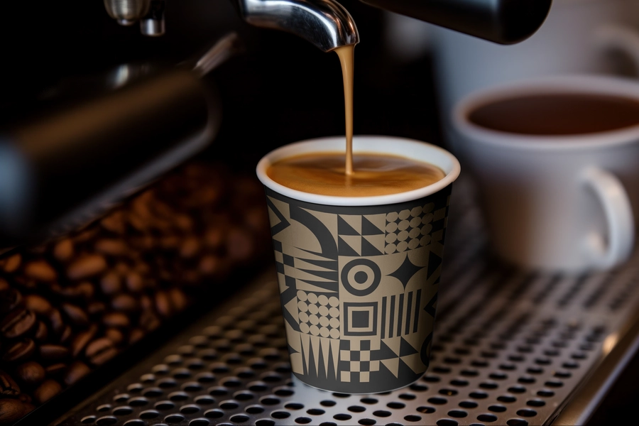 IVO branded coffee cup being filled at an espresso machine